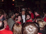 John Kerry posing with supporters wearing 'Real Deal' T-shirts